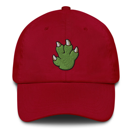 Red baseball cap with pixel art green dinosaur paw embroidery, playful dad hat
